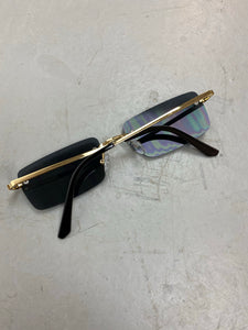 Black tinted gold metal framed sunglasses